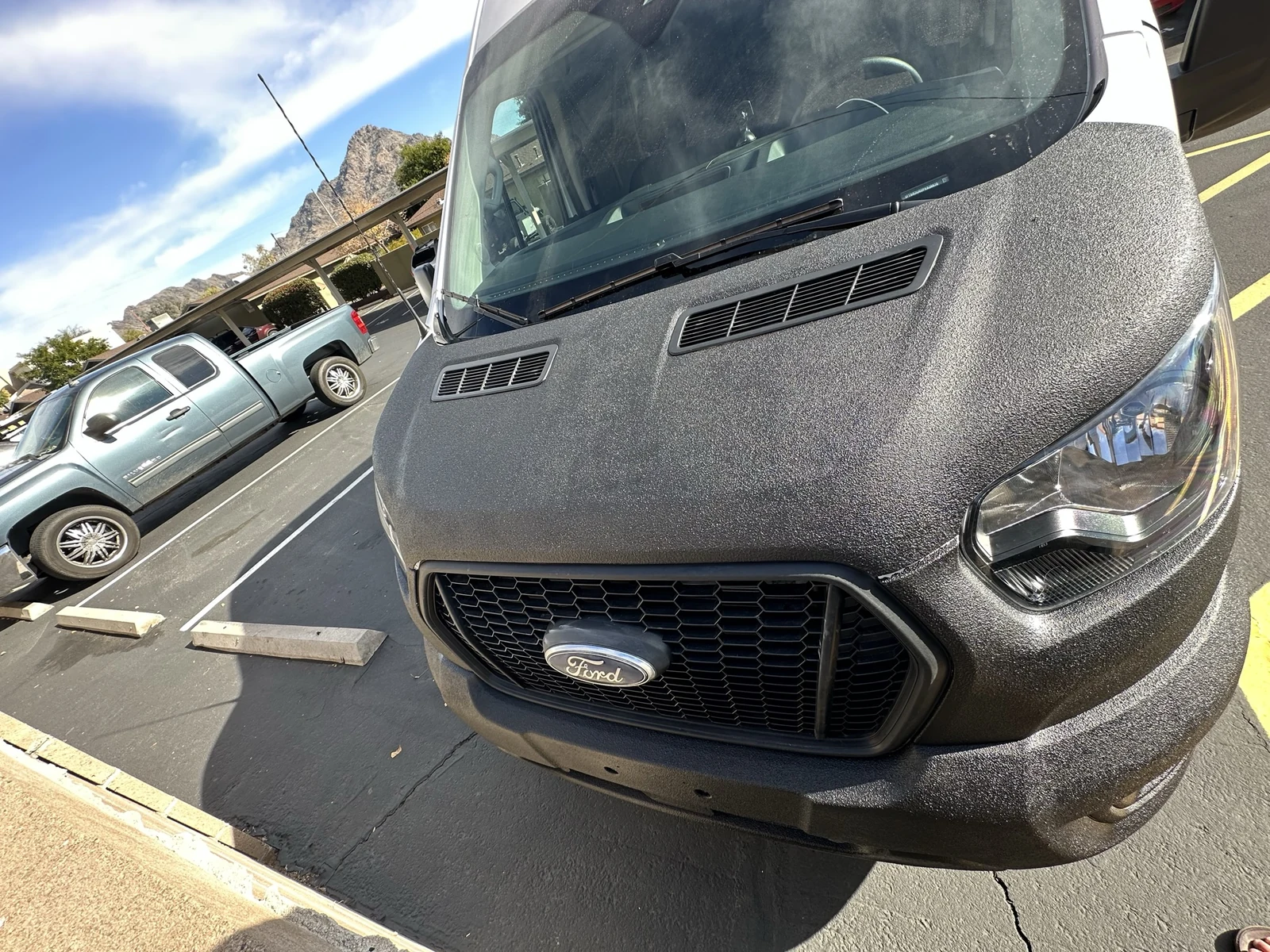 Close view of the black textured hood and front of my Transit after coating.