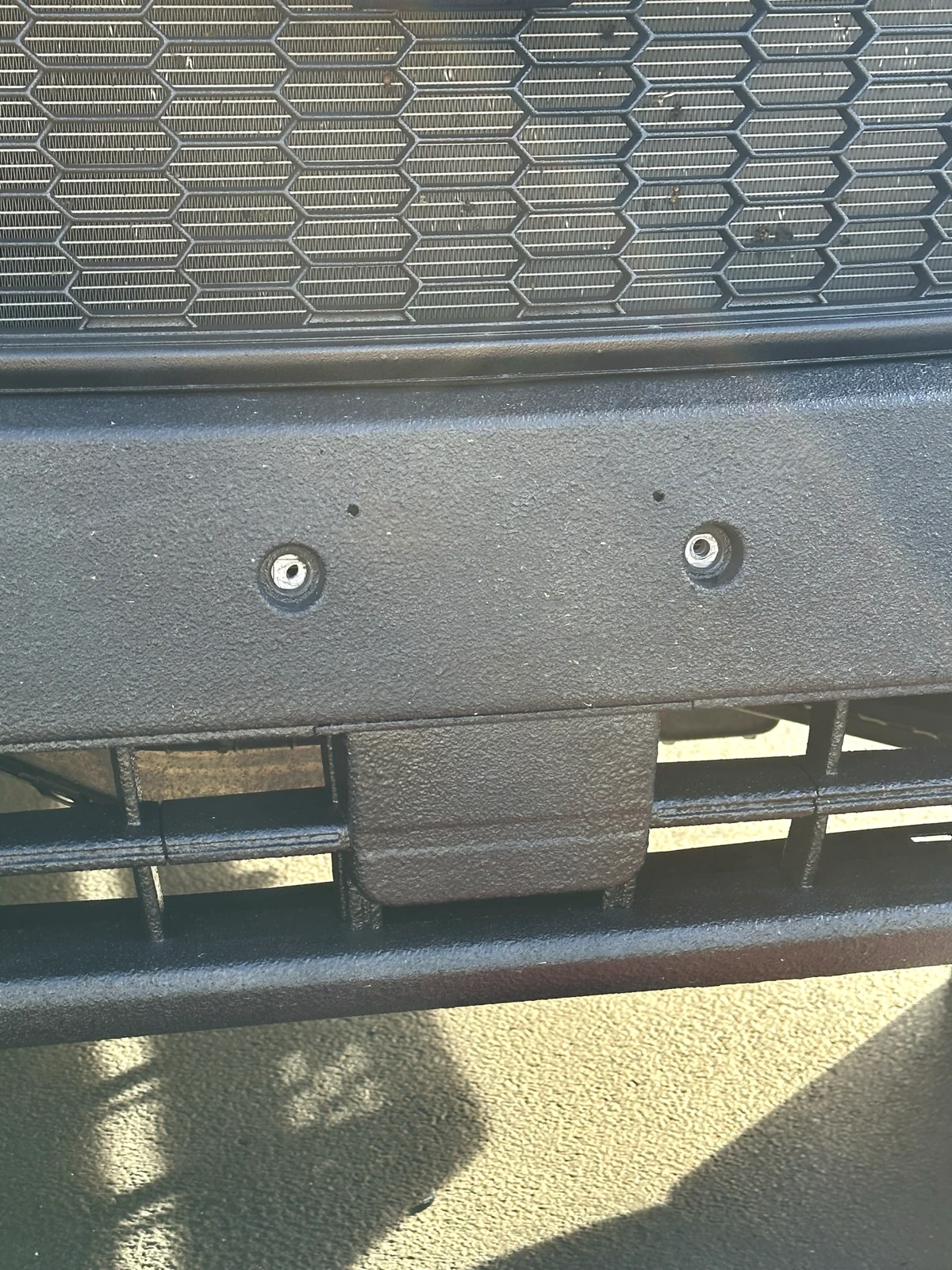 Two exposed threaded openings at the former front license-plate bracket position on my Transit