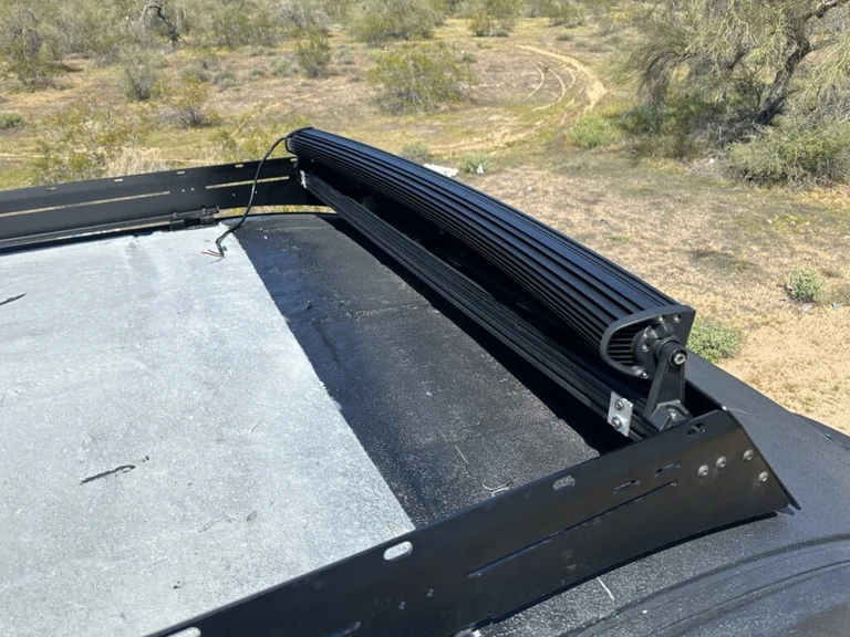 The 54-inch light bar and its brackets mounted to my van roof rack in daylight