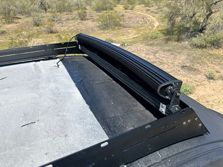The 54-inch light bar and its brackets mounted to my van roof rack in daylight