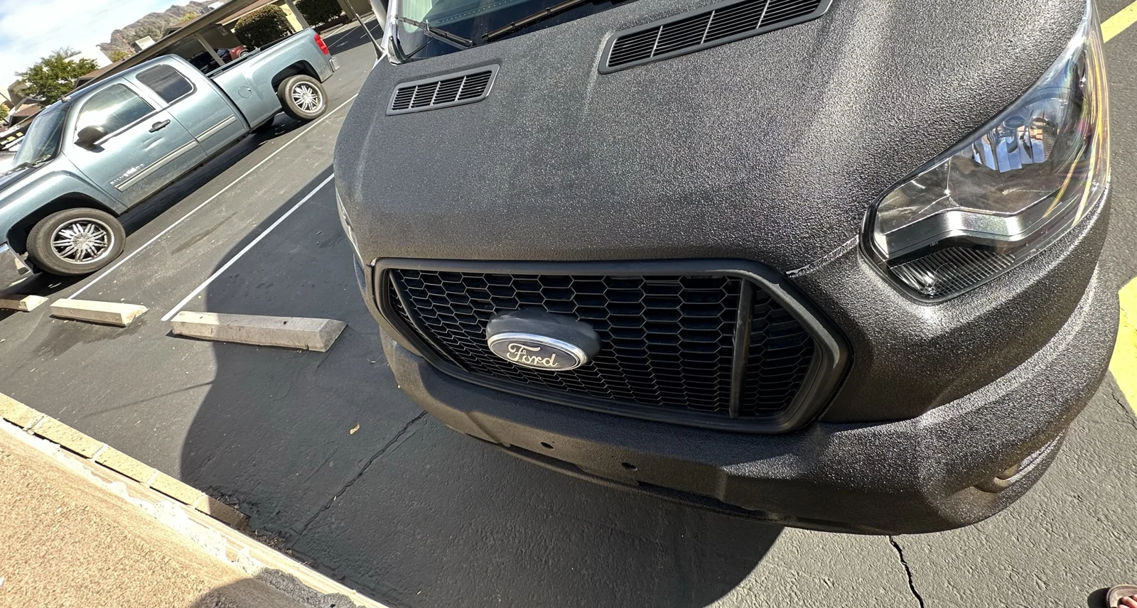 The hood and front bumper, with the grille and vent inserts still visibly distinct.