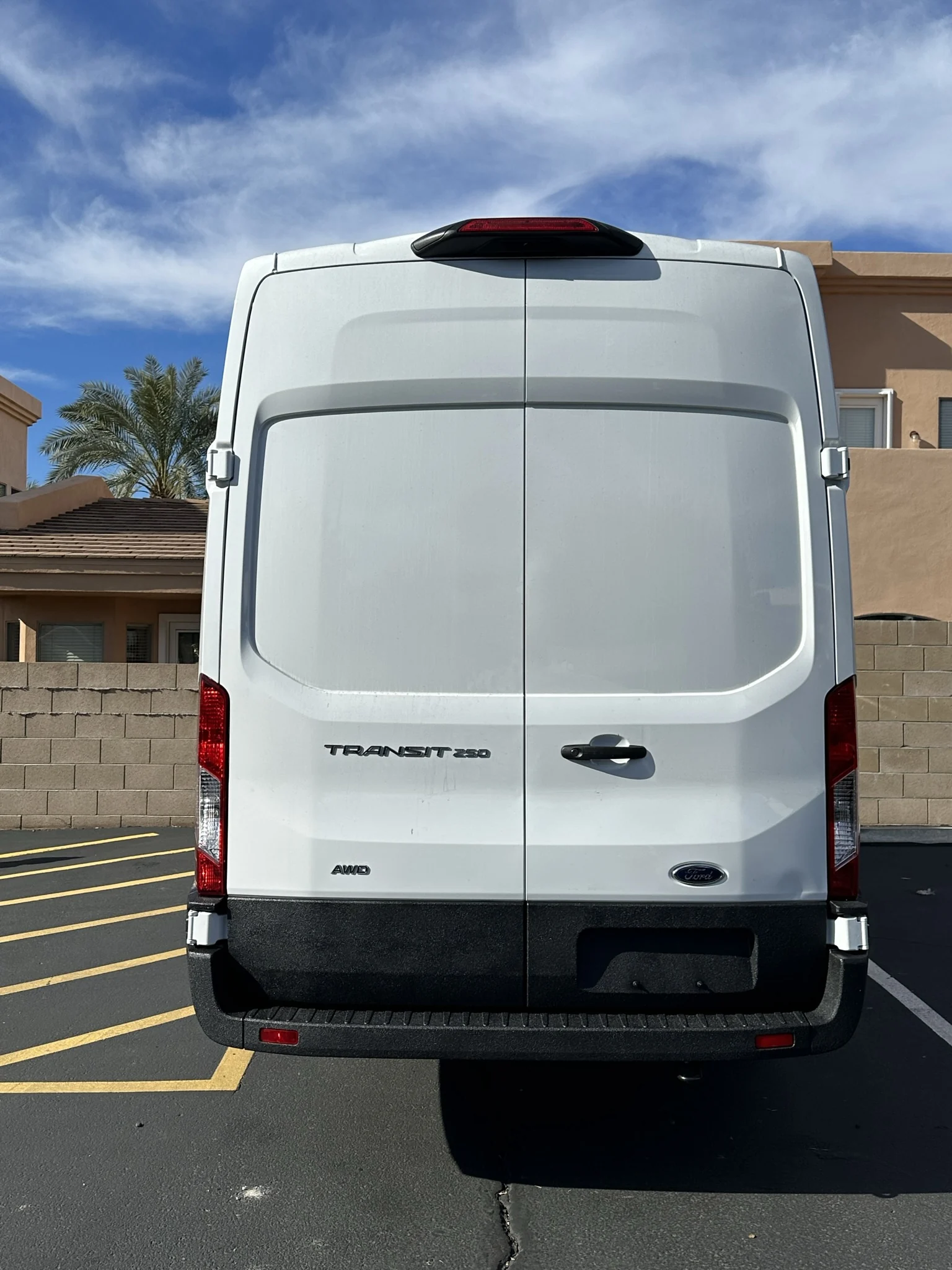 Black-coated lower rear doors and bumper against the white upper body.