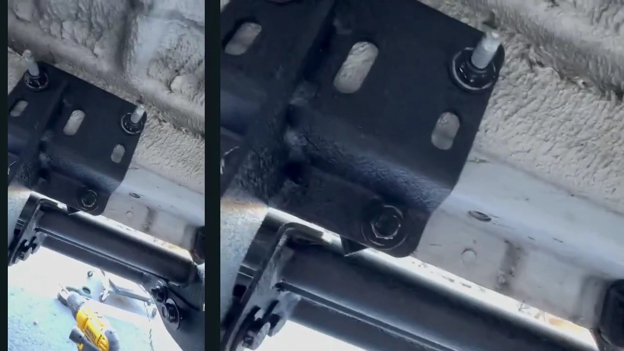 The black running-board bracket attached beneath the van, with its upper plate and fasteners visible.