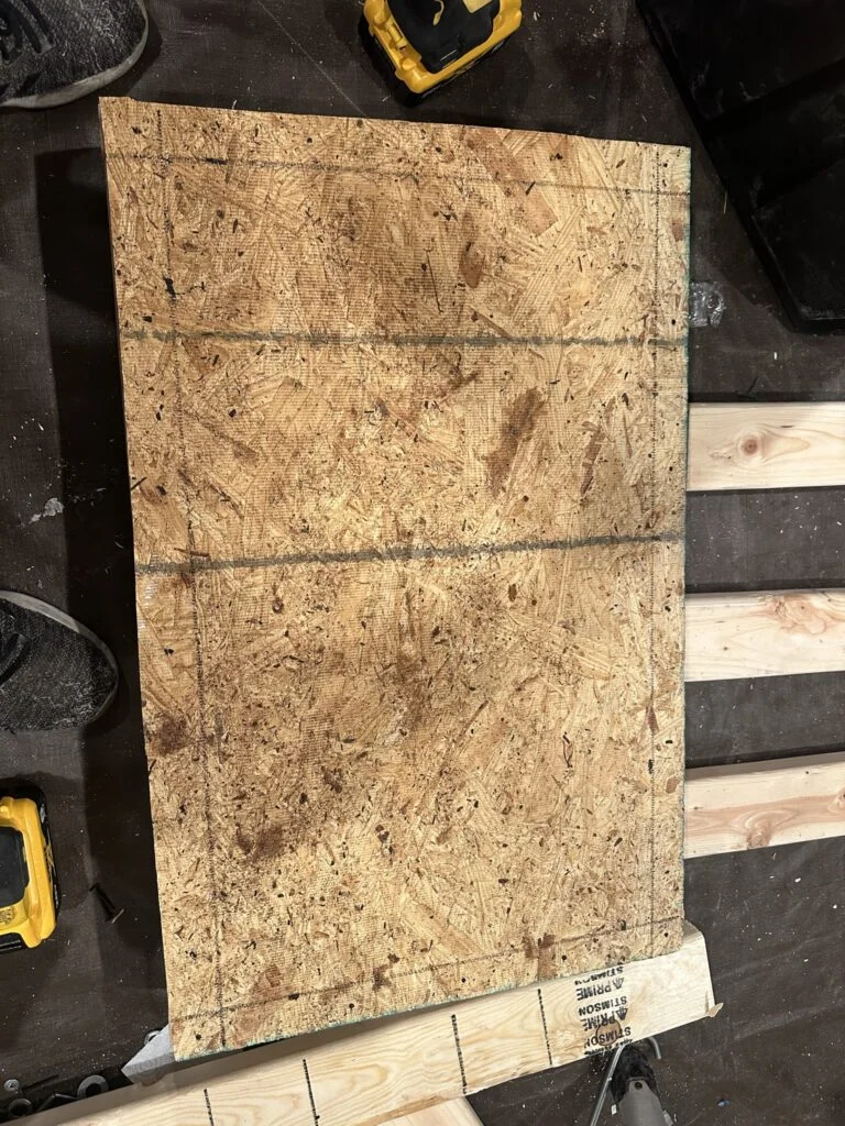 The marked drawer-base panel during the storage assembly work.