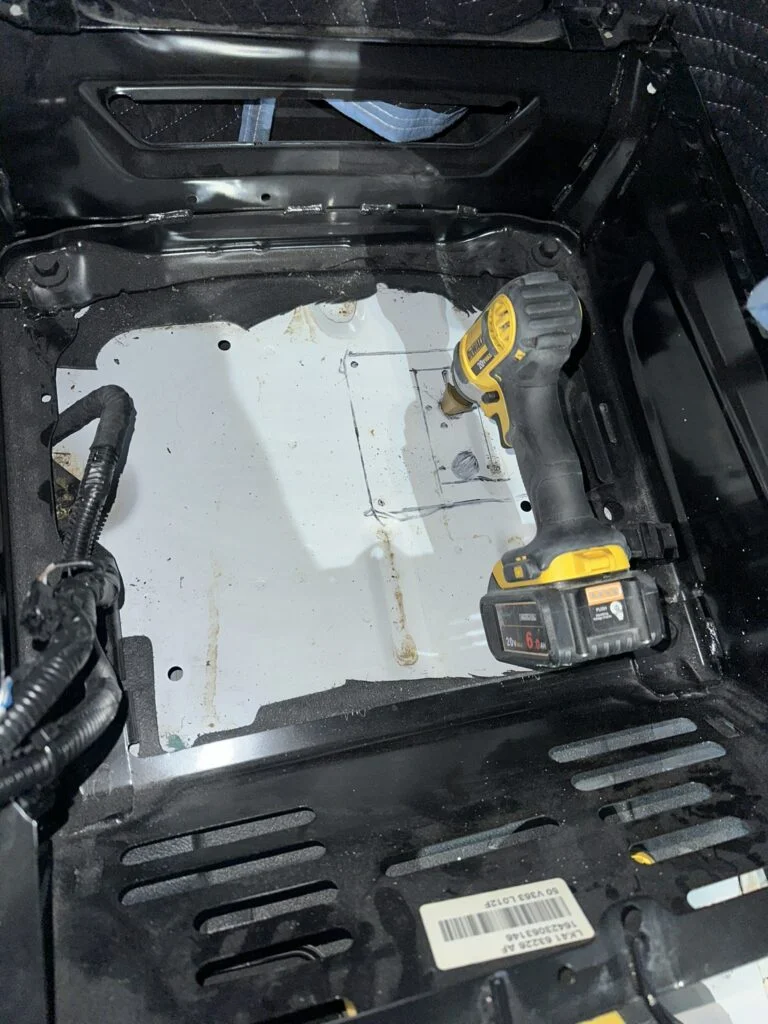 A drill at the starter opening beneath my passenger seat.