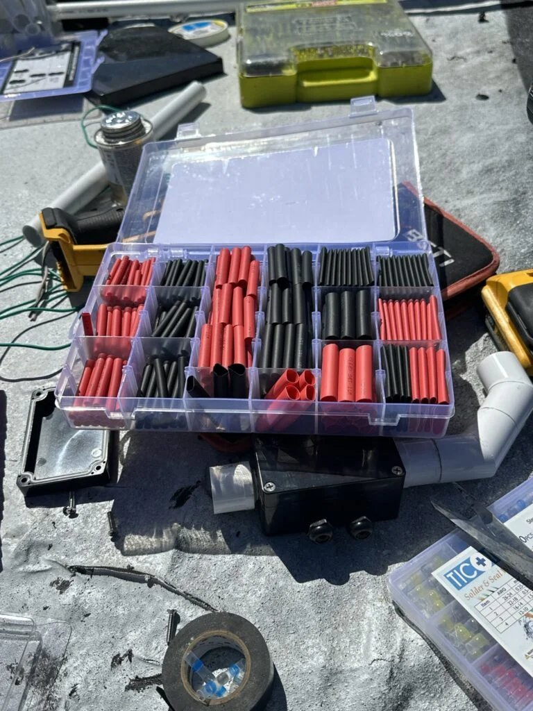 Heat-gun and wire-covering work during the roof-wiring project.