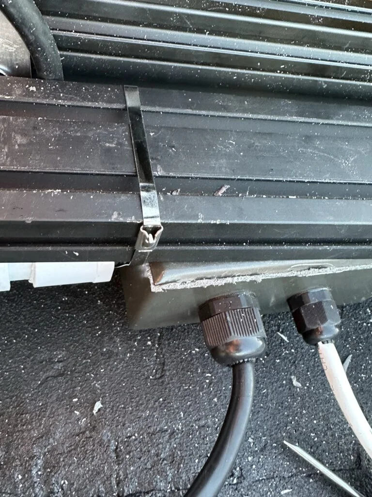 The pipe, box and mounting arrangement beside the rack.