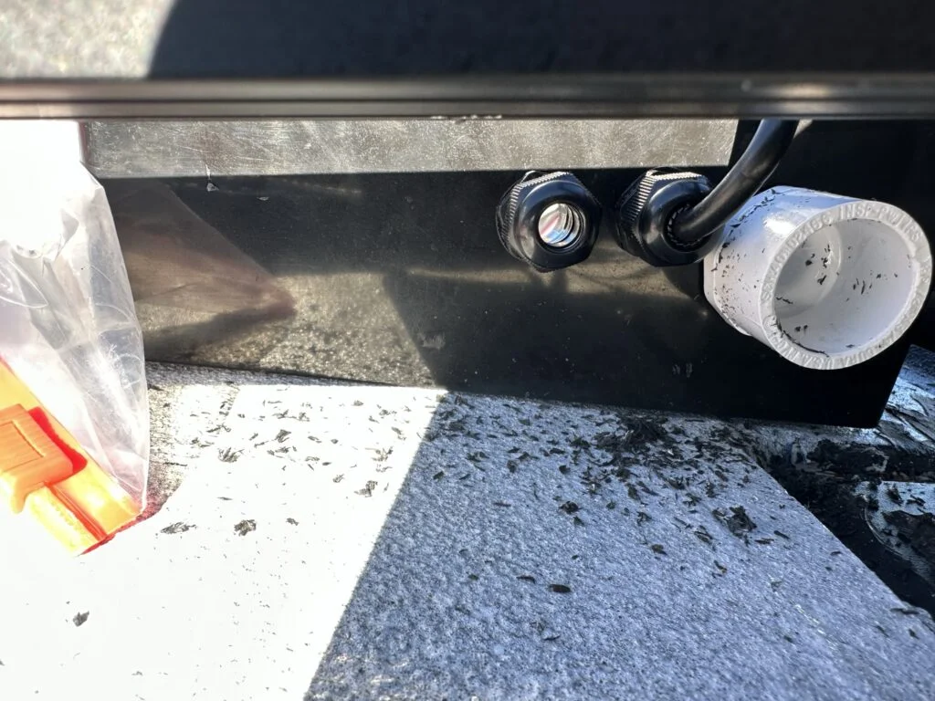 Cable and PVC entry fittings at the side of the large roof enclosure.