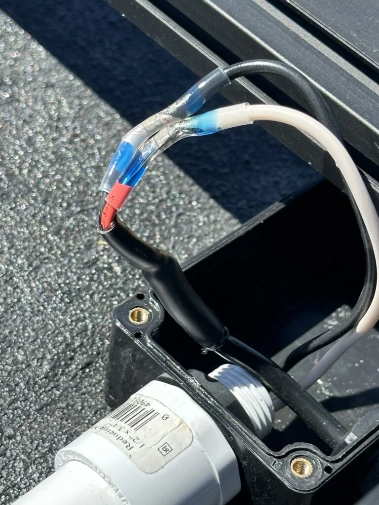 Wire-connection work during the last session of the roof-routing stage.
