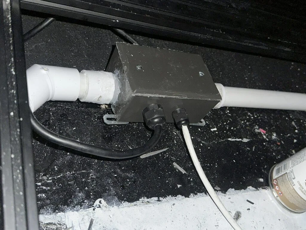 A bend and straight pipe section beside a junction box in my roof route.