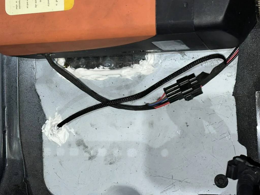 The wire entry and connector pair inside the van.