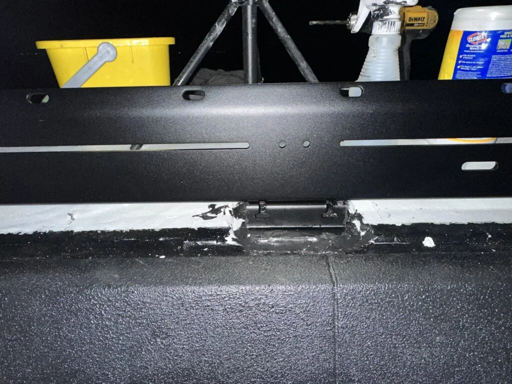A landing pad beneath the roof-rack side rail.