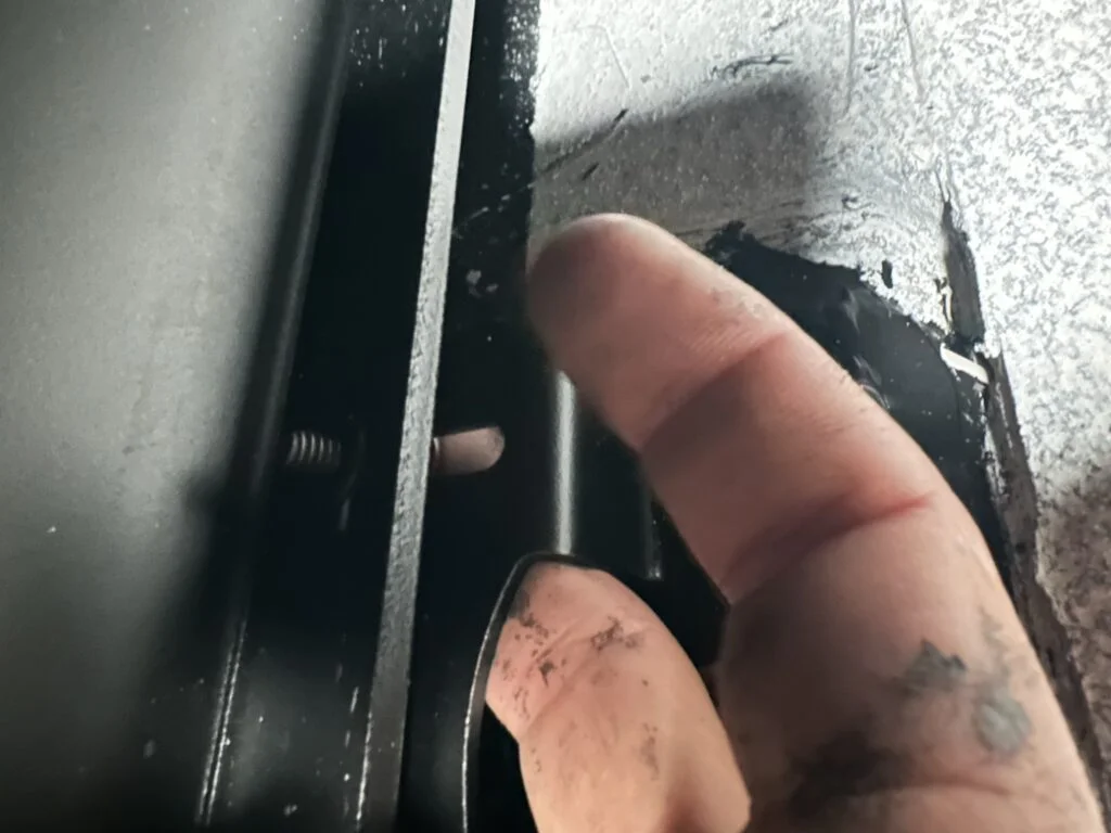 The tight space around the roof-rack attachment during fitting.