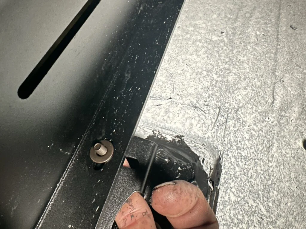 Sealant at a landing-pad location and on my fingers during roof-rack assembly.
