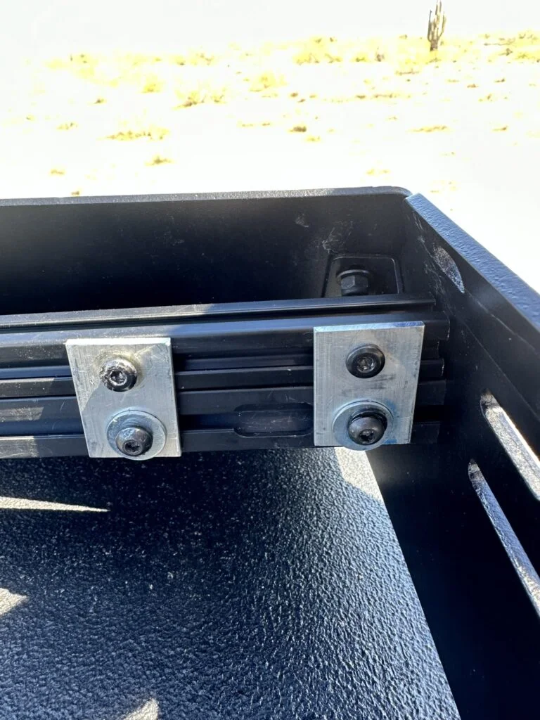The drilled connectors and fasteners joining my added extrusion to the roof rack.