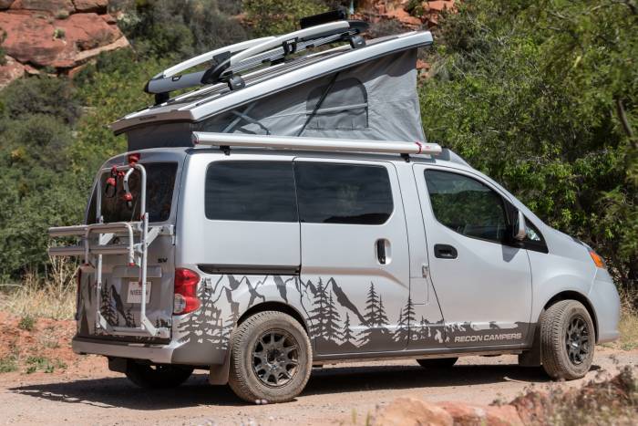 nissan nv converted into a camper van with a popup bed area