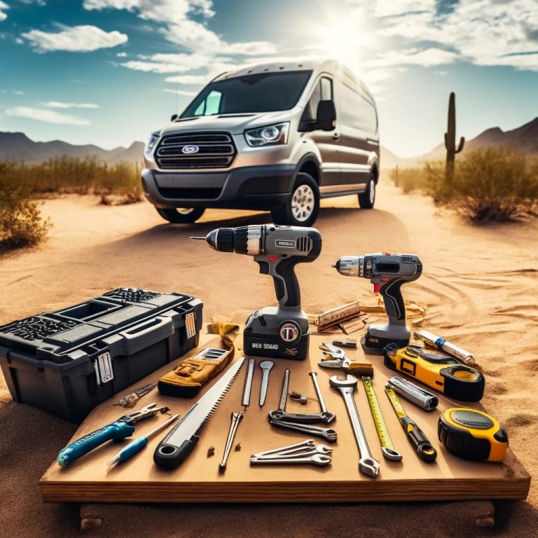 Various essential tools for van conversion, including a cordless drill, saw, and hammer, displayed on desert ground with a 2023 Ford Transit van in the background, in Phoenix, AZ.